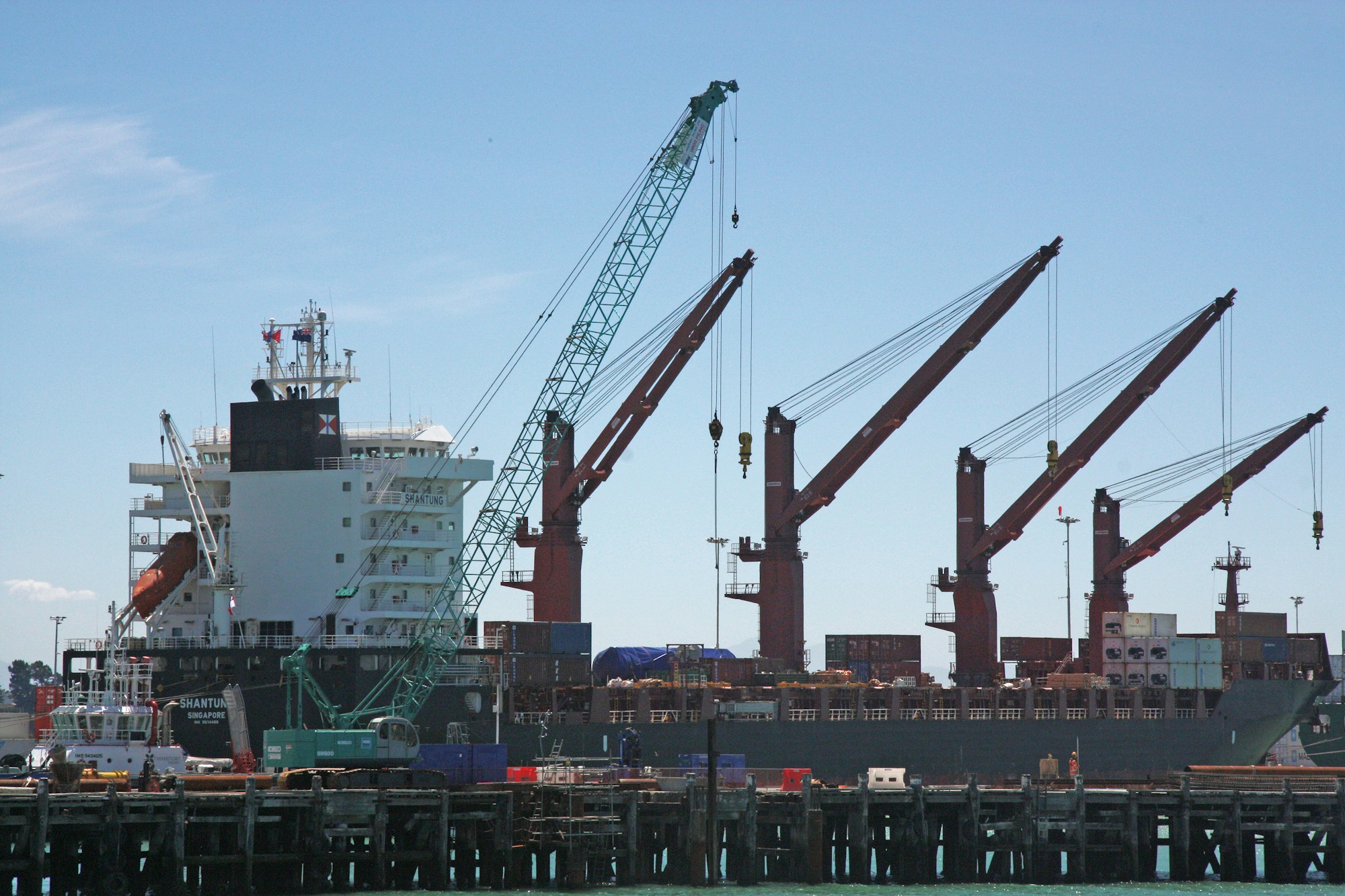 Illustrative stock photograph of working port cranes along a waterfront